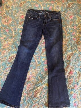 American Eagle Outfitters Dark Blue Flare Jeans with blue sequin pockets